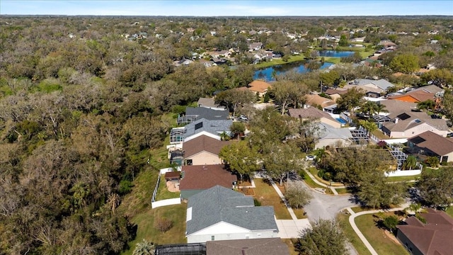 birds eye view of property featuring a water view and a residential view