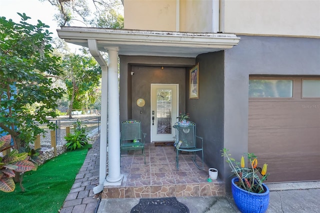 view of exterior entry featuring a garage