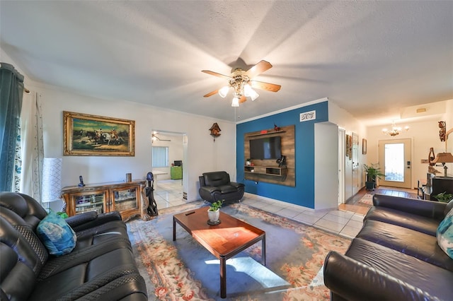 living room with ceiling fan with notable chandelier, a textured ceiling, and light tile patterned flooring