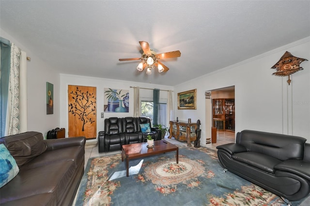 tiled living room with a textured ceiling, ceiling fan, and crown molding