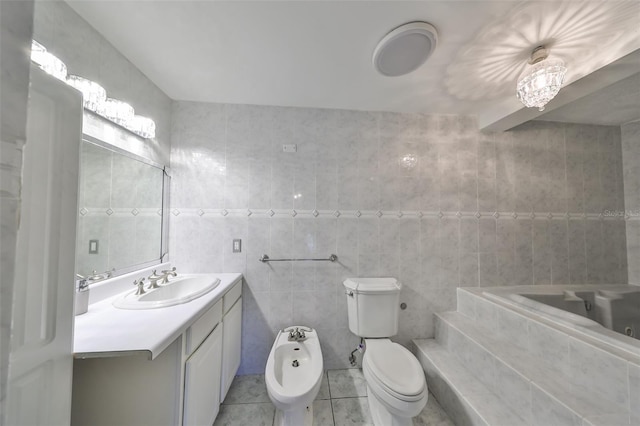 bathroom featuring tile patterned floors, a bidet, toilet, vanity, and tile walls