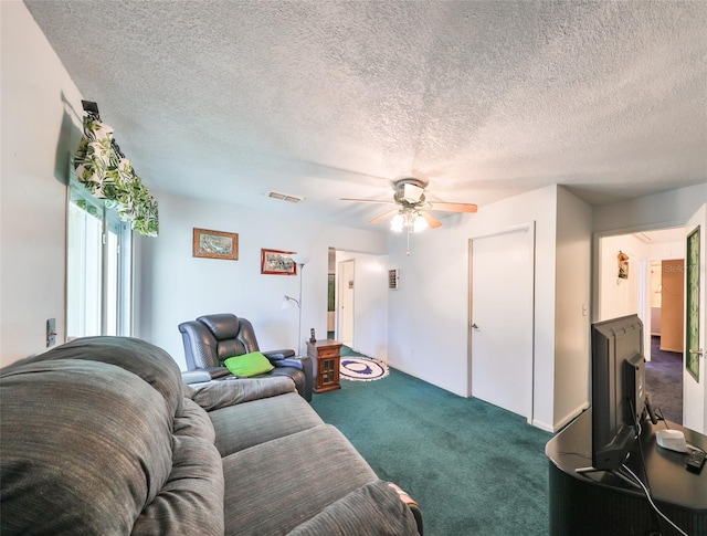 carpeted living room with a textured ceiling and ceiling fan