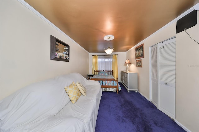 bedroom with dark colored carpet, a closet, and ornamental molding