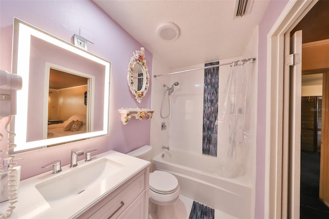 full bathroom with shower / tub combo, vanity, a textured ceiling, and toilet