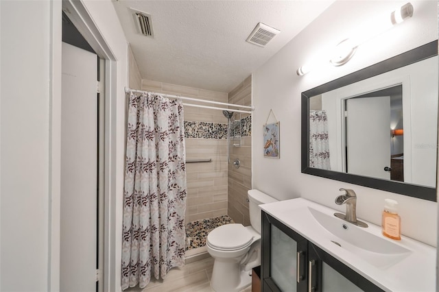 bathroom with vanity, toilet, a textured ceiling, walk in shower, and wood-type flooring