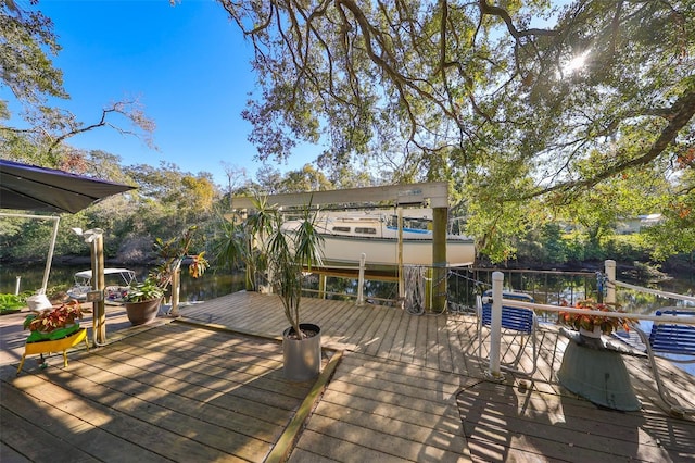 deck with a dock and a water view