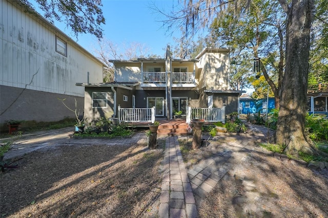 rear view of property with a balcony