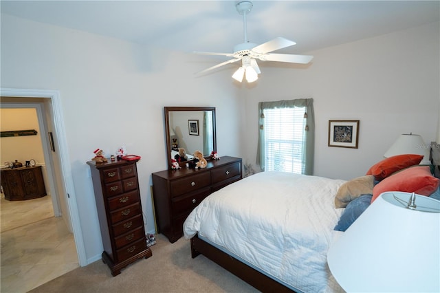 bedroom featuring light carpet and ceiling fan