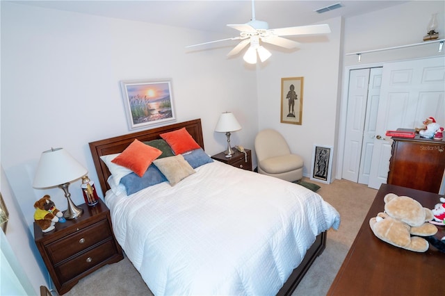 carpeted bedroom featuring ceiling fan and a closet