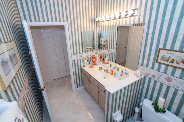 bathroom featuring vanity and toilet