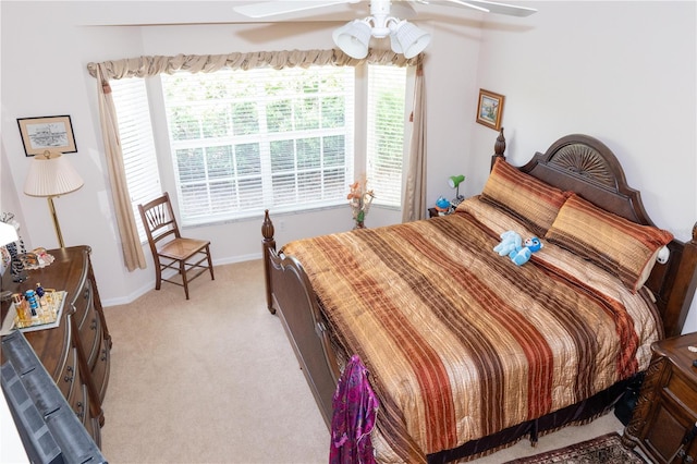 bedroom with light carpet and ceiling fan