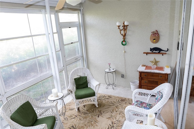 sunroom featuring ceiling fan