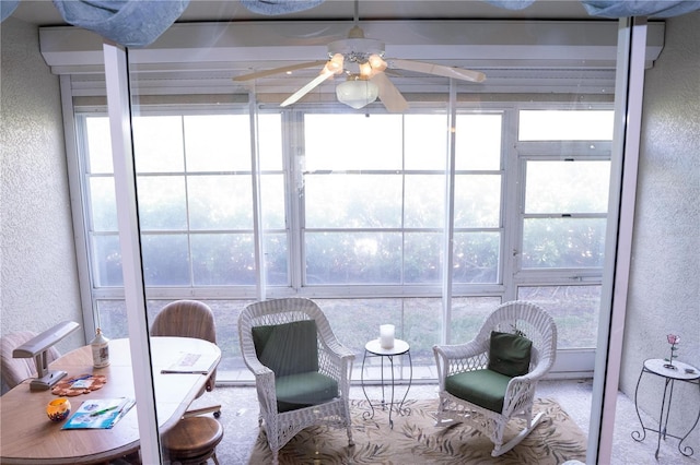 sunroom featuring ceiling fan and a wealth of natural light