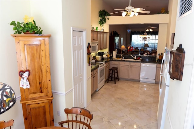 kitchen with ceiling fan, sink, and white appliances