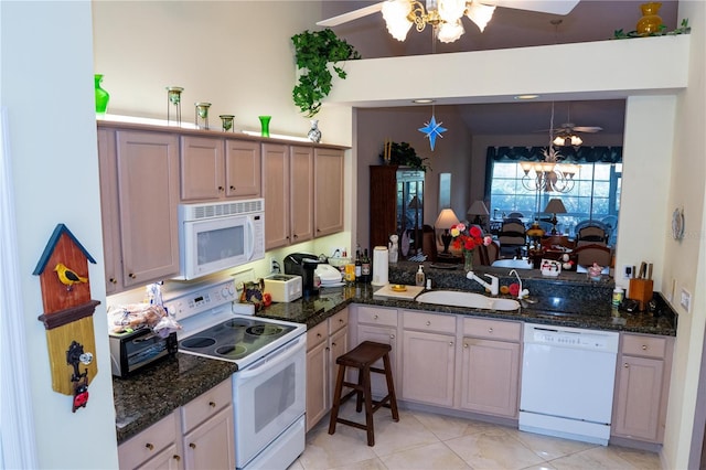 kitchen with sink, white appliances, hanging light fixtures, kitchen peninsula, and ceiling fan