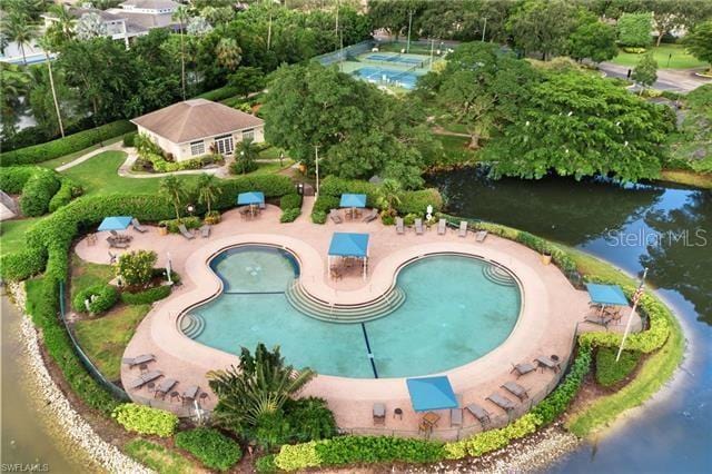 view of swimming pool with a water view and a patio area