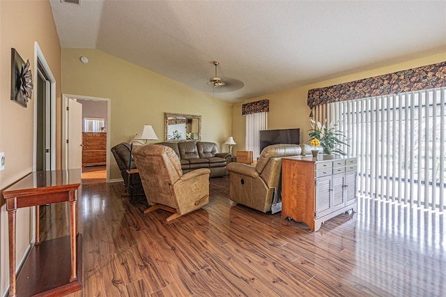 living room featuring hardwood / wood-style flooring and lofted ceiling