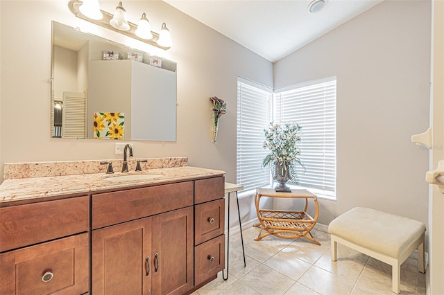 bathroom with vanity, tile patterned floors, and lofted ceiling