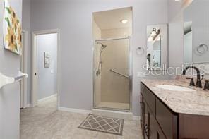 bathroom with vanity and an enclosed shower