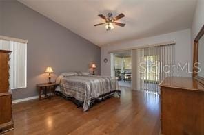 bedroom with hardwood / wood-style flooring, ceiling fan, lofted ceiling, and access to outside