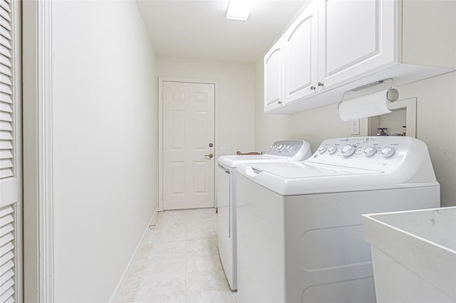 laundry room with cabinets, sink, and washing machine and clothes dryer