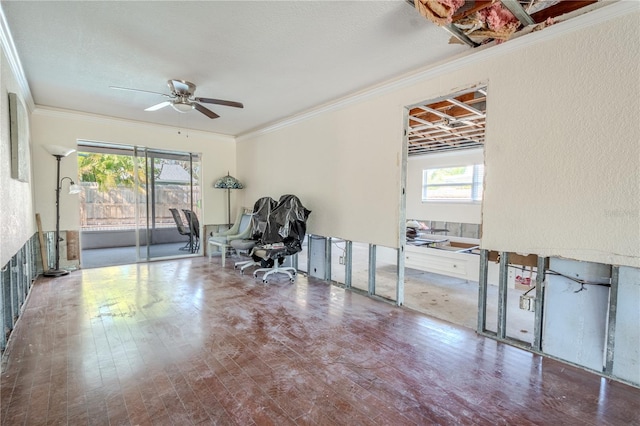 sitting room featuring a wealth of natural light, crown molding, and ceiling fan