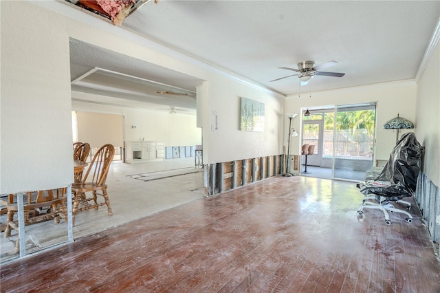 misc room with a textured ceiling, ceiling fan, wood-type flooring, and crown molding