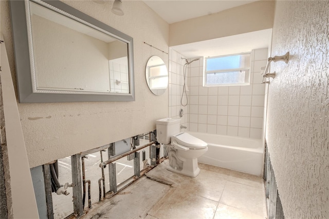 bathroom featuring toilet and tiled shower / bath