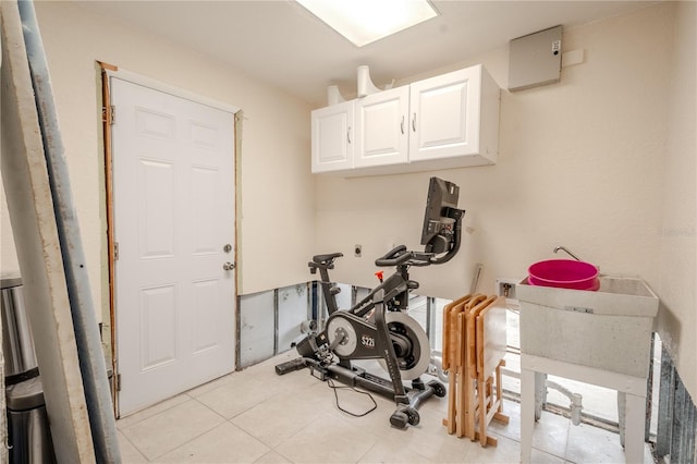 exercise area featuring light tile patterned flooring