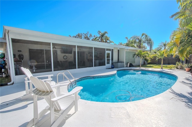 view of swimming pool featuring a sunroom