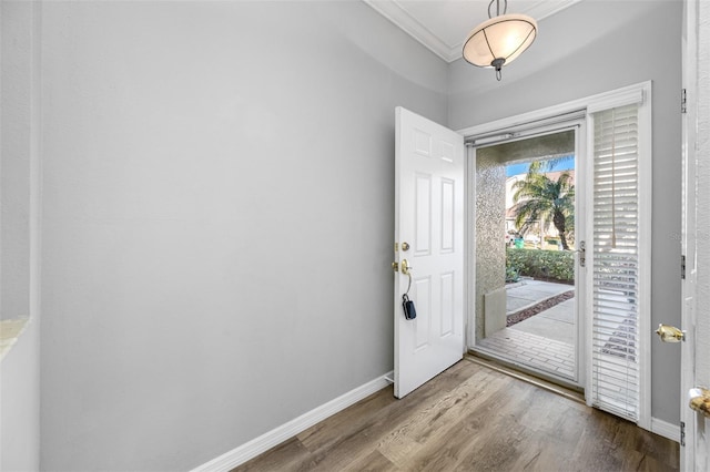 foyer with hardwood / wood-style floors and crown molding