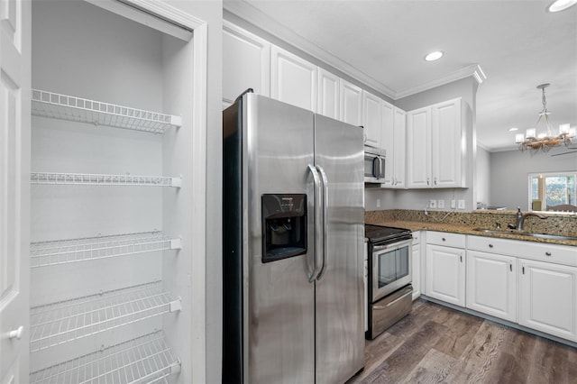 kitchen with stainless steel appliances, white cabinetry, pendant lighting, crown molding, and dark wood-type flooring