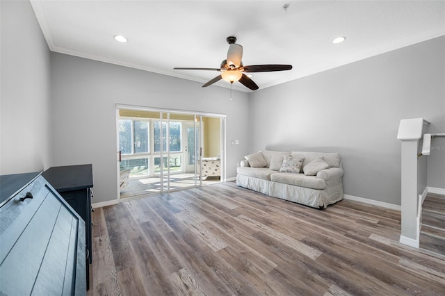 living room with ceiling fan, ornamental molding, and hardwood / wood-style flooring