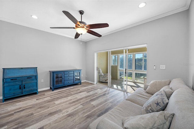 living room featuring ceiling fan, crown molding, and light hardwood / wood-style flooring