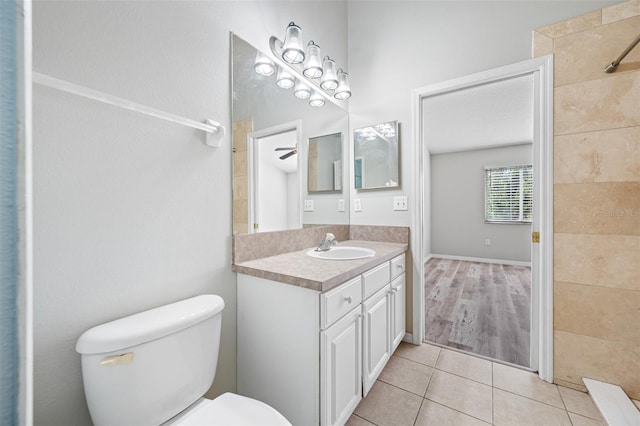 bathroom featuring toilet, tile patterned flooring, ceiling fan, and vanity