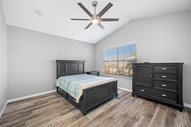 bedroom featuring ceiling fan, vaulted ceiling, and wood-type flooring