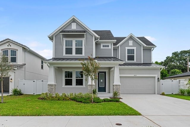 craftsman inspired home with a garage and a front lawn