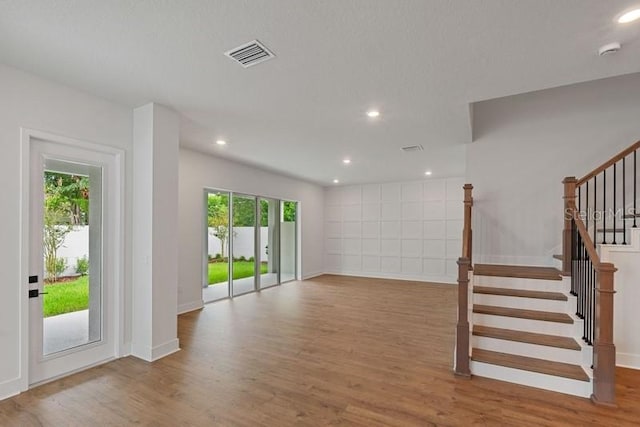 unfurnished living room with hardwood / wood-style floors and a wealth of natural light