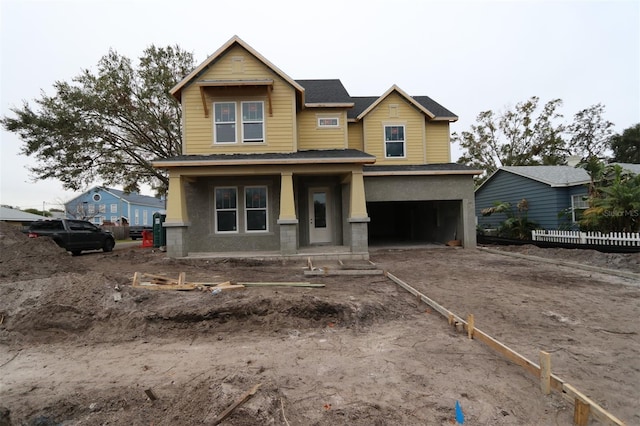 craftsman-style home featuring a porch and a garage