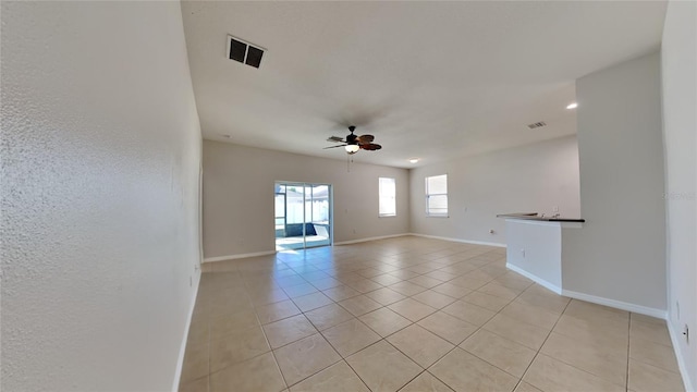 unfurnished room with light tile patterned flooring and ceiling fan