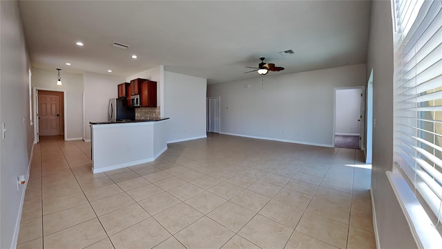 kitchen featuring appliances with stainless steel finishes, ceiling fan, decorative backsplash, and light tile patterned floors