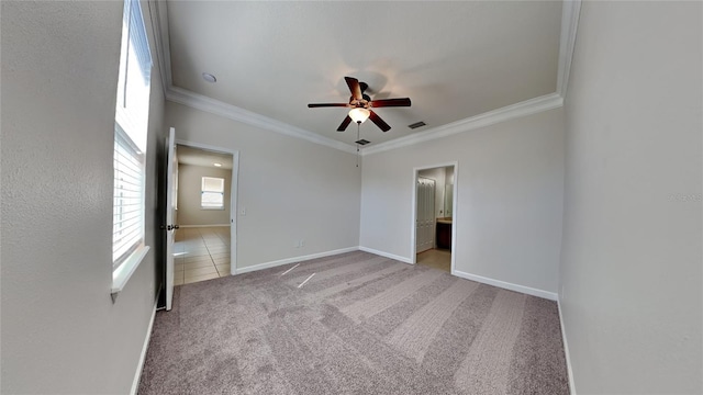 unfurnished bedroom with connected bathroom, ceiling fan, crown molding, and light colored carpet