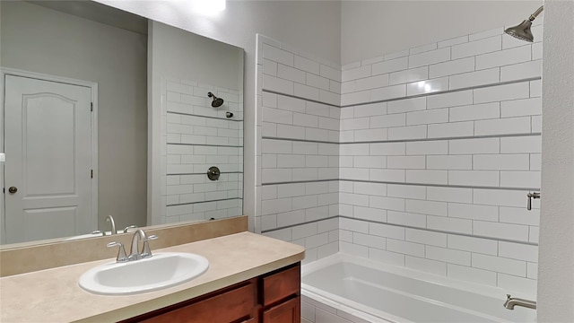 bathroom with tiled shower / bath and vanity