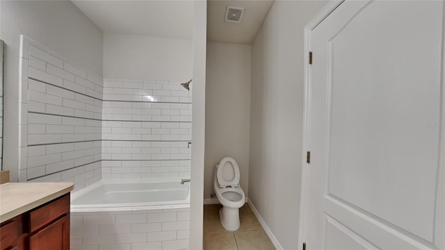 full bathroom featuring toilet, vanity, tile patterned flooring, and tiled shower / bath combo