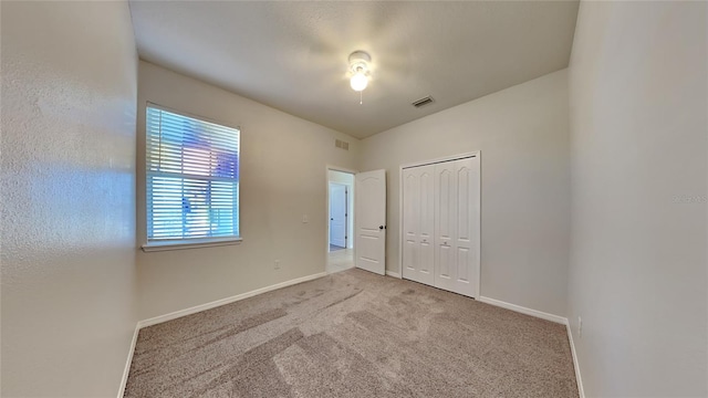 unfurnished bedroom featuring a closet and carpet flooring