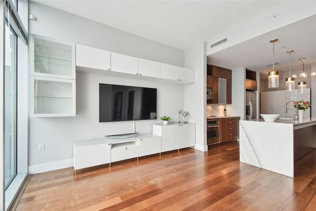 unfurnished living room featuring light wood-type flooring