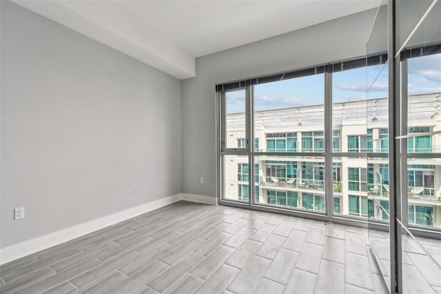 empty room featuring a wall of windows