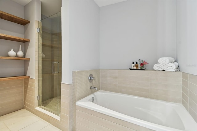 bathroom with tile patterned floors and shower with separate bathtub