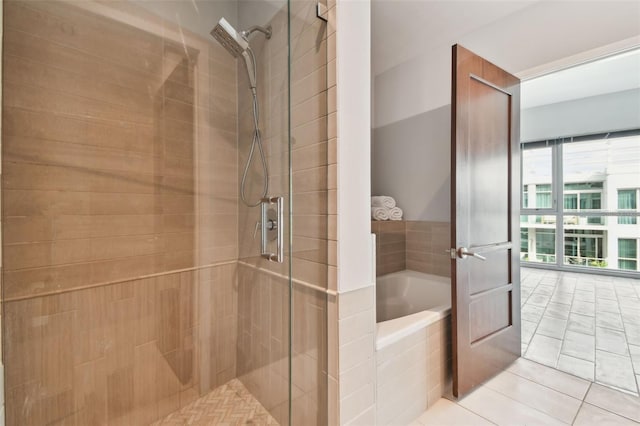 bathroom featuring tile patterned flooring and independent shower and bath