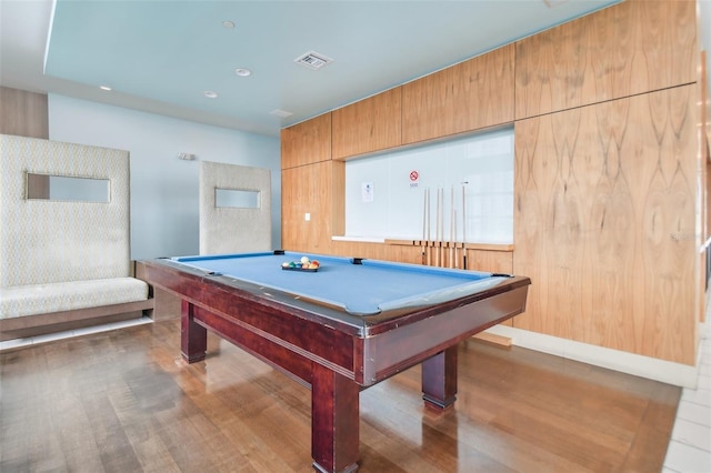 game room with hardwood / wood-style flooring, wooden walls, and pool table